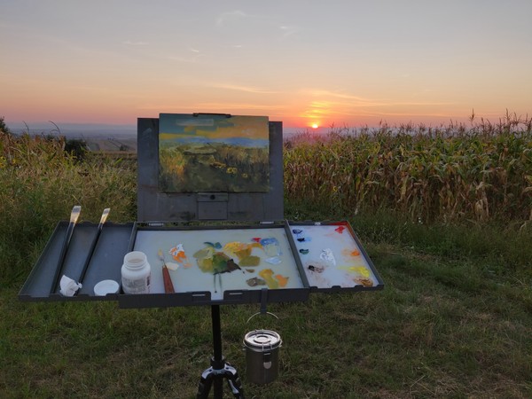 Sunset landscape painting on easel